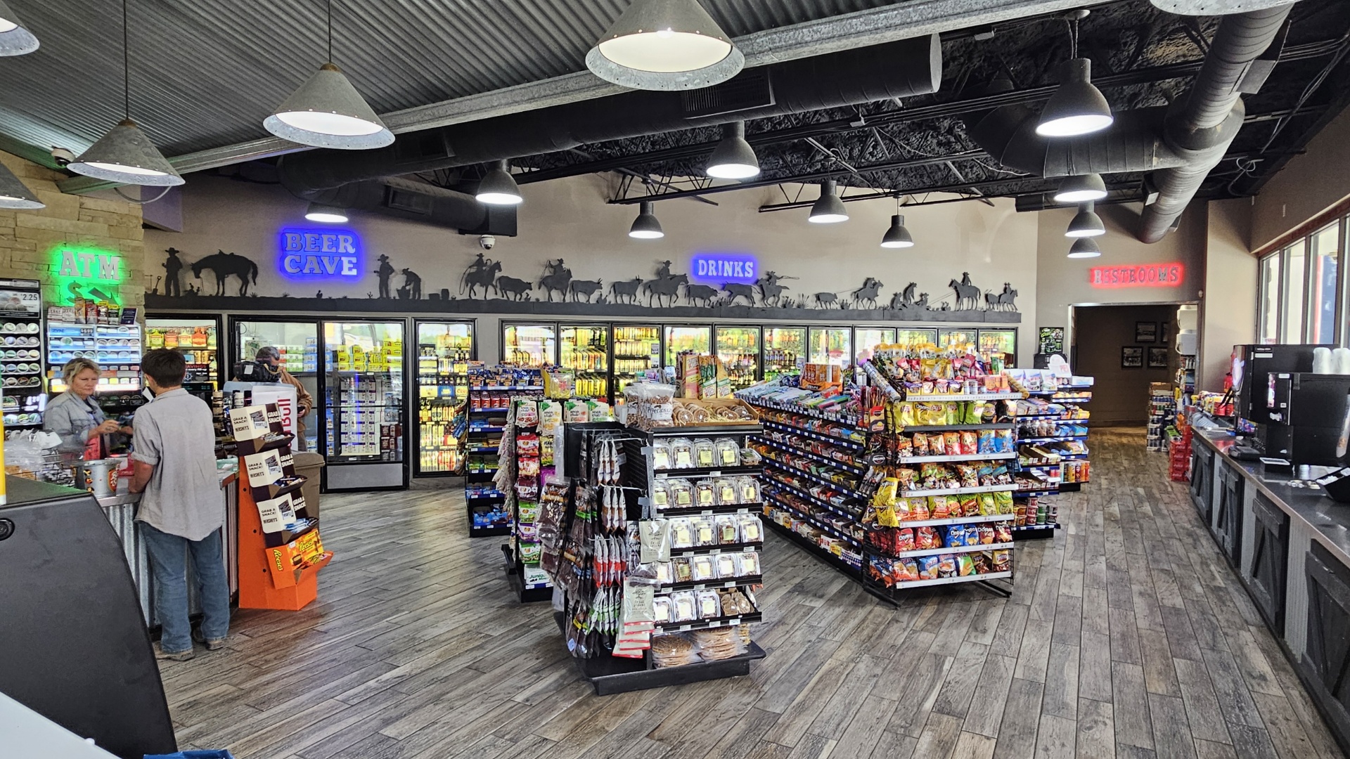 Inside Quick Check — beer cave, drinks aisle, and overhead lighting